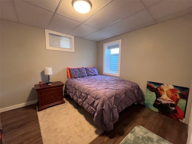502 Illinois Ave, Valier, MT 59486 - bedroom with a paneled ceiling, wood finished floors, and baseboards