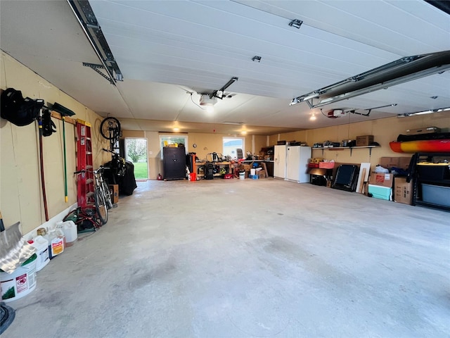 502 Illinois Ave, Valier, MT 59486 - garage featuring a garage door opener and freestanding refrigerator
