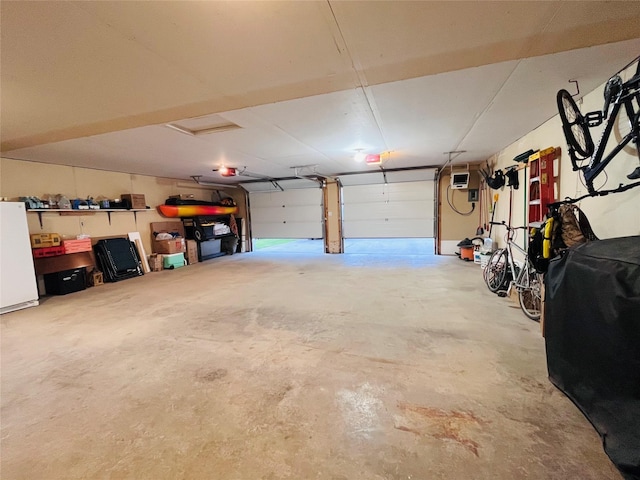 502 Illinois Ave, Valier, MT 59486 - garage featuring freestanding refrigerator and a garage door opener