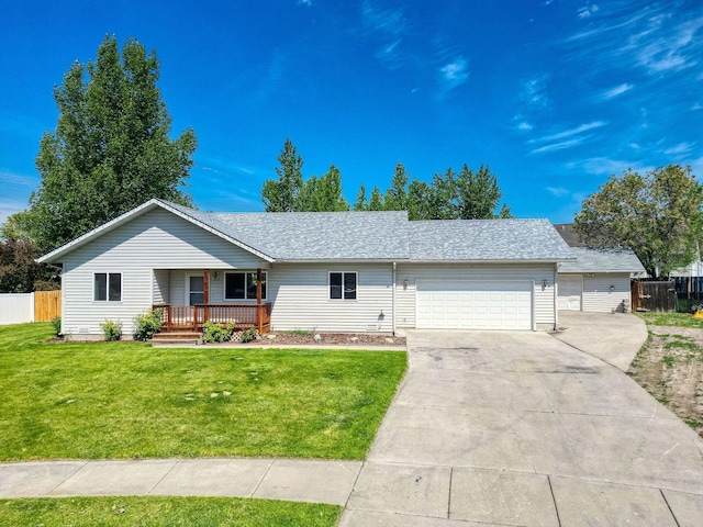 144 Beargrass Ln, Kalispell, MT 59901 - ranch-style home with covered porch, an attached garage, and driveway