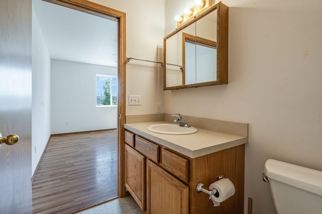 144 Beargrass Ln, Kalispell, MT 59901 - half bathroom featuring vanity, toilet, and wood finished floors