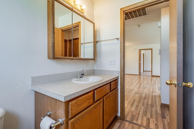 144 Beargrass Ln, Kalispell, MT 59901 - bathroom with vanity, wood finished floors, and toilet