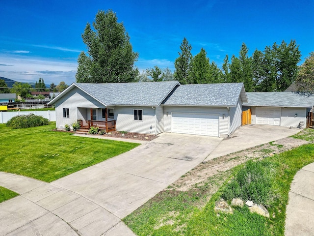 144 Beargrass Ln, Kalispell, MT 59901 - ranch-style home featuring covered porch, a garage, concrete driveway, and roof with shingles
