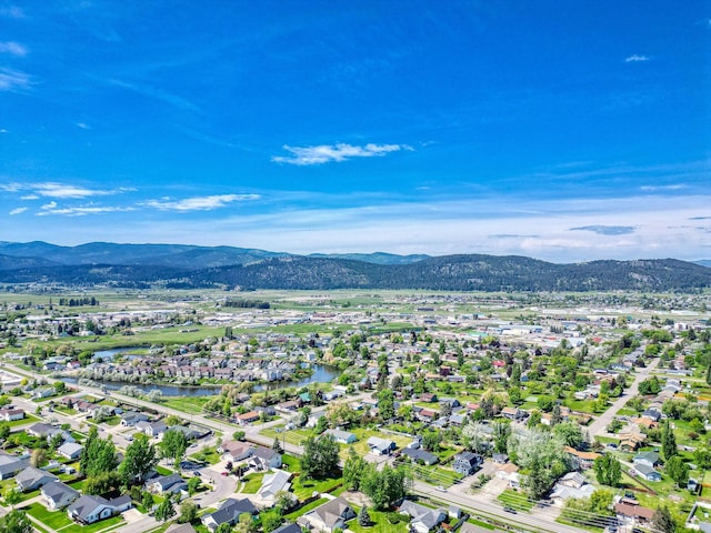144 Beargrass Ln, Kalispell, MT 59901 - aerial view of property and surrounding area featuring a mountainous background and nearby suburban area
