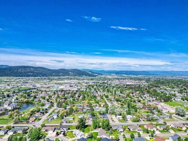 144 Beargrass Ln, Kalispell, MT 59901 - aerial overview of property's location featuring a mountainous background and nearby suburban area