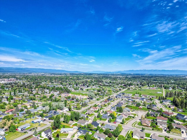 144 Beargrass Ln, Kalispell, MT 59901 - aerial overview of property's location with a mountainous background and nearby suburban area