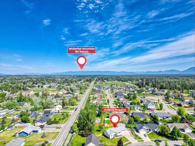 144 Beargrass Ln, Kalispell, MT 59901 - aerial perspective of suburban area featuring a mountain backdrop