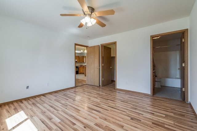 144 Beargrass Ln, Kalispell, MT 59901 - unfurnished bedroom with light wood-style flooring, ensuite bath, a ceiling fan, and baseboards