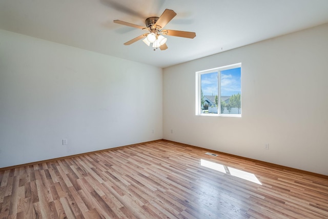 144 Beargrass Ln, Kalispell, MT 59901 - spare room with light wood finished floors, a ceiling fan, and baseboards