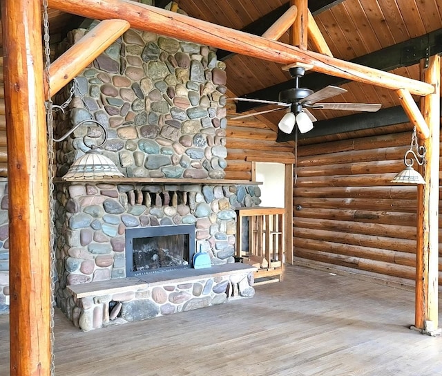 438 Little Mill Creek Rd, Saint Regis, MT 59866 - unfurnished living room featuring log walls, wooden ceiling, wood finished floors, ceiling fan, and a fireplace