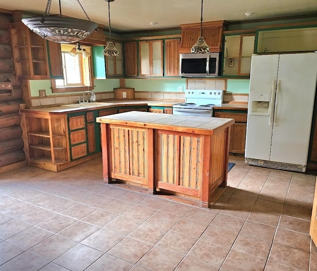 438 Little Mill Creek Rd, Saint Regis, MT 59866 - kitchen featuring white appliances, a sink, a kitchen island, tile counters, and light tile patterned floors