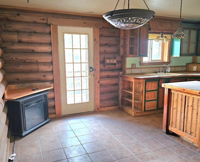 438 Little Mill Creek Rd, Saint Regis, MT 59866 - kitchen featuring open shelves, a sink, log walls, light countertops, and light tile patterned floors