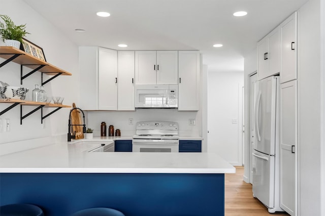 1337A Lily Ct, Missoula, MT 59802 - kitchen with white appliances, a peninsula, open shelves, recessed lighting, and light wood finished floors