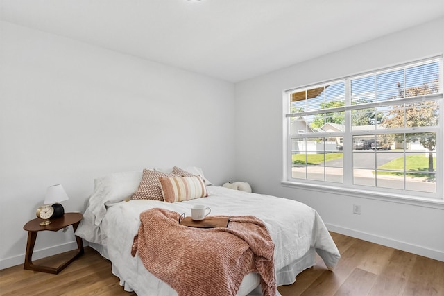 1337A Lily Ct, Missoula, MT 59802 - bedroom featuring multiple windows, baseboards, and wood finished floors