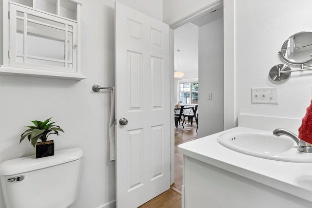 1337A Lily Ct, Missoula, MT 59802 - bathroom featuring wood finished floors, toilet, and vanity