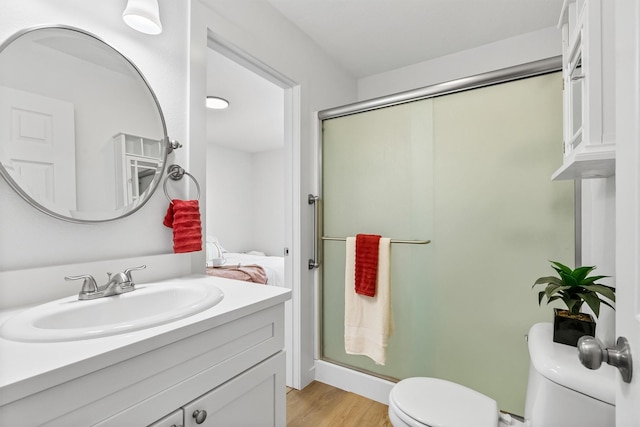 1337A Lily Ct, Missoula, MT 59802 - bathroom featuring toilet, a stall shower, vanity, and wood finished floors