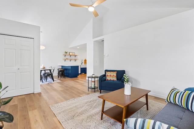 1337A Lily Ct, Missoula, MT 59802 - living area with light wood-type flooring, ceiling fan, high vaulted ceiling, and baseboards