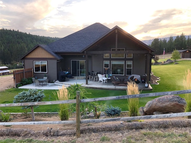20 Penny Ln, Clancy, MT 59634 - back of house at dusk with a patio area, an outdoor living space, and a shingled roof
