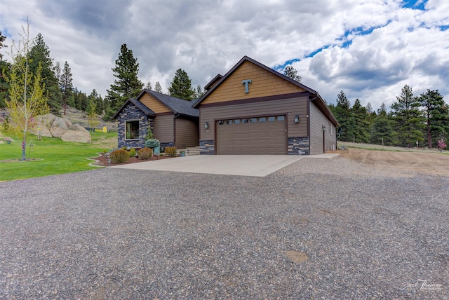 20 Penny Ln, Clancy, MT 59634 - view of front facade featuring stone siding, driveway, and an attached garage