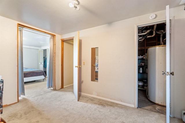 2404 56th St, Missoula, MT 59803 - unfurnished bedroom featuring carpet flooring, water heater, baseboards, and baseboard heating
