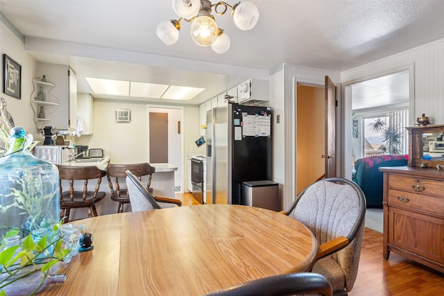 2404 56th St, Missoula, MT 59803 - dining area with light wood finished floors and a chandelier