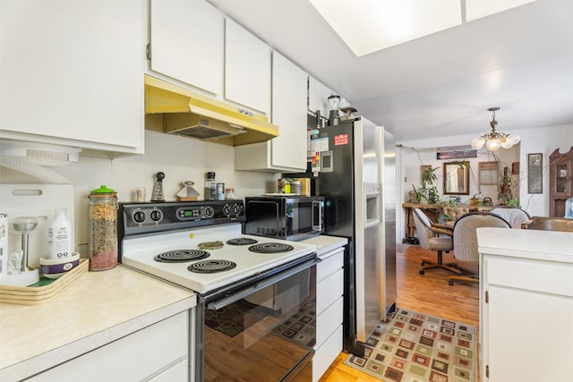 2404 56th St, Missoula, MT 59803 - kitchen featuring electric stove, black microwave, under cabinet range hood, light countertops, and light wood-type flooring