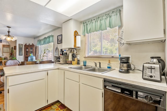2404 56th St, Missoula, MT 59803 - kitchen with a sink, dishwasher, a peninsula, light countertops, and a chandelier