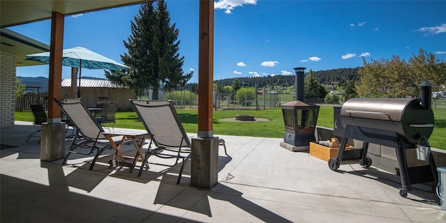 345 Ash Dr, Butte, MT 59701 - view of patio featuring a fire pit and a wooded view