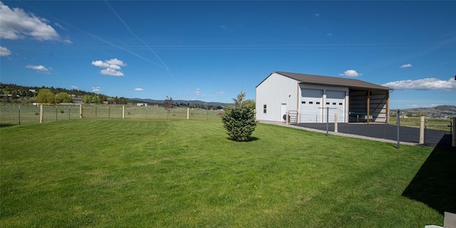 345 Ash Dr, Butte, MT 59701 - view of yard with an outdoor structure, a detached garage, and a mountain view
