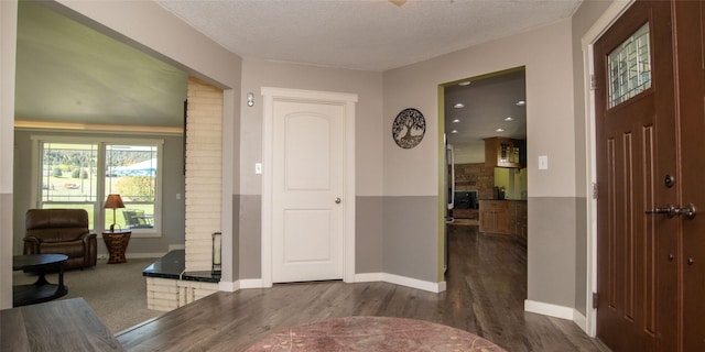 345 Ash Dr, Butte, MT 59701 - foyer entrance featuring dark wood-type flooring, baseboards, and a textured ceiling