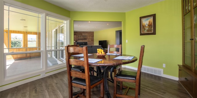 345 Ash Dr, Butte, MT 59701 - dining space featuring dark wood-style flooring, baseboards, and a stone fireplace