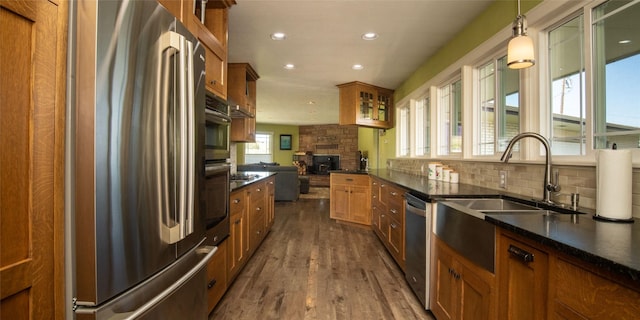 345 Ash Dr, Butte, MT 59701 - kitchen featuring appliances with stainless steel finishes, brown cabinetry, dark wood finished floors, a sink, and recessed lighting