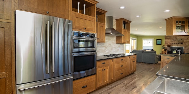 345 Ash Dr, Butte, MT 59701 - kitchen with stainless steel appliances, wall chimney exhaust hood, open shelves, tasteful backsplash, and light wood-style floors