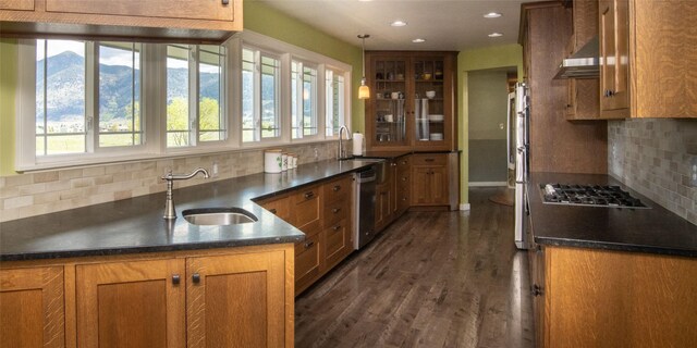345 Ash Dr, Butte, MT 59701 - kitchen with stainless steel appliances, wall chimney exhaust hood, open shelves, tasteful backsplash, and light wood-style floors