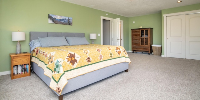 345 Ash Dr, Butte, MT 59701 - bedroom with carpet flooring, a closet, baseboards, and a textured ceiling