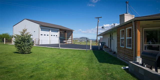 345 Ash Dr, Butte, MT 59701 - view of grassy yard with a garage, an outbuilding, and a mountain view