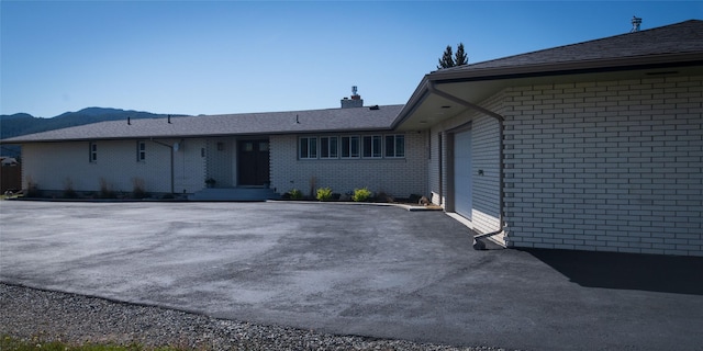 345 Ash Dr, Butte, MT 59701 - view of front facade featuring brick siding and a chimney
