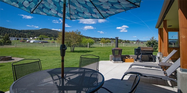345 Ash Dr, Butte, MT 59701 - view of patio / terrace featuring outdoor dining area, a mountain view, a fire pit, and a view of countryside