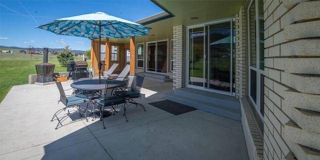 345 Ash Dr, Butte, MT 59701 - view of patio featuring entry steps, a mountain view, and outdoor dining space