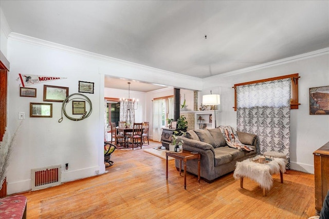 1712 1st Ave N, Great Falls, MT 59401 - living room featuring a chandelier, crown molding, light wood-style floors, and baseboards