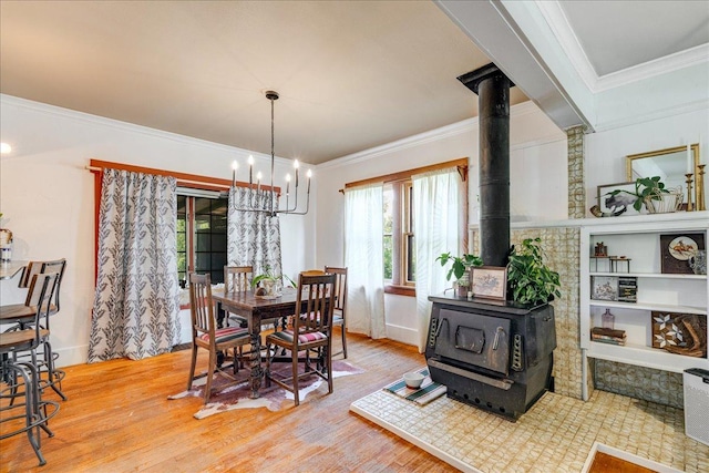 1712 1st Ave N, Great Falls, MT 59401 - dining space with a wood stove, a chandelier, wood finished floors, and crown molding