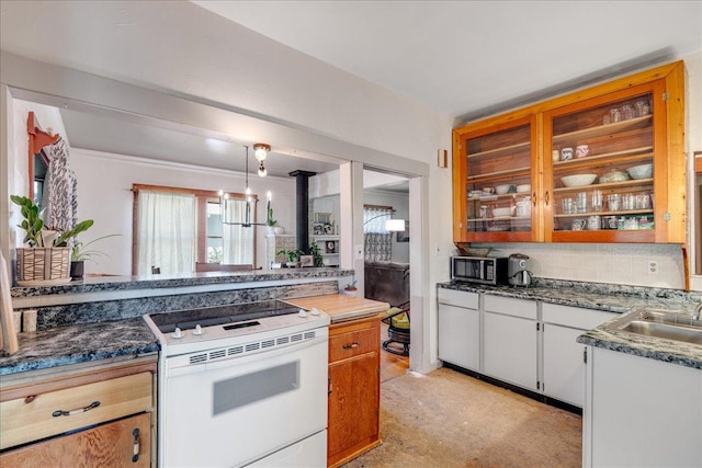 1712 1st Ave N, Great Falls, MT 59401 - kitchen with white electric stove, stainless steel microwave, dark countertops, a sink, and decorative light fixtures