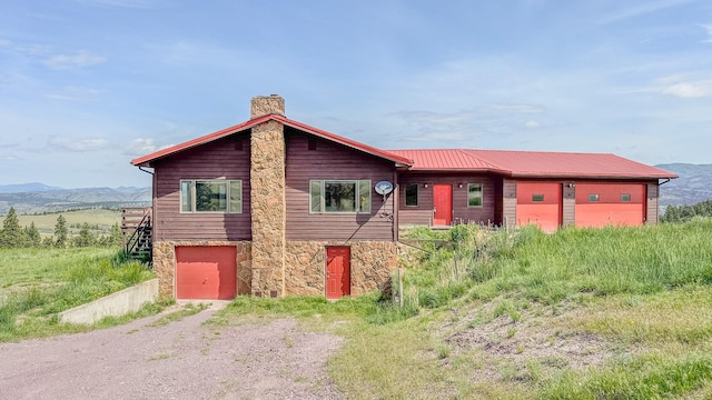 6180 Elkhorn Rd, Helena, MT 59602 - chalet / cabin with a chimney, stone siding, driveway, and a mountain view