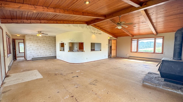 6180 Elkhorn Rd, Helena, MT 59602 - unfurnished living room featuring a wood stove, a ceiling fan, a baseboard radiator, plenty of natural light, and wooden ceiling