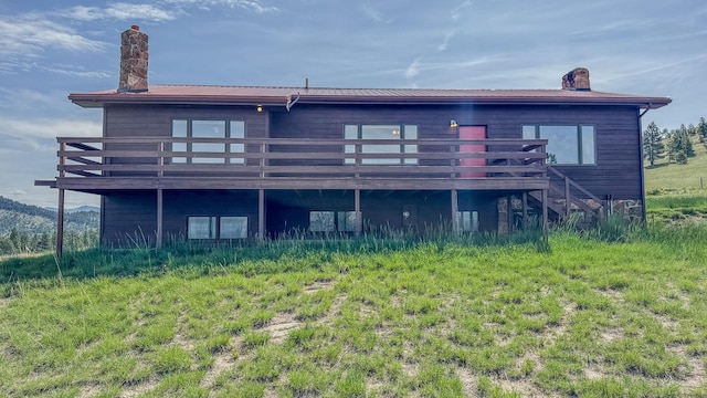 6180 Elkhorn Rd, Helena, MT 59602 - back of house with a chimney, a wooden deck, and stairway