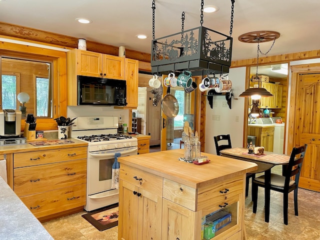 30 Williams Gulch Loop, Philipsburg, MT 59858 - kitchen with white range with gas cooktop, black microwave, wooden counters, light brown cabinetry, and washer and dryer