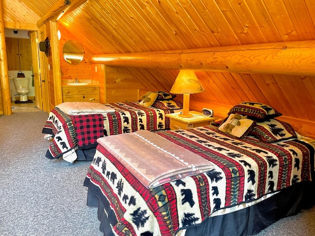 30 Williams Gulch Loop, Philipsburg, MT 59858 - bedroom featuring a wooden ceiling with exposed beams, carpet, wood walls, and connected bathroom