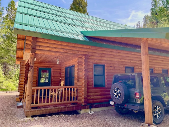 30 Williams Gulch Loop, Philipsburg, MT 59858 - view of side of home with log exterior, a metal roof, and covered porch