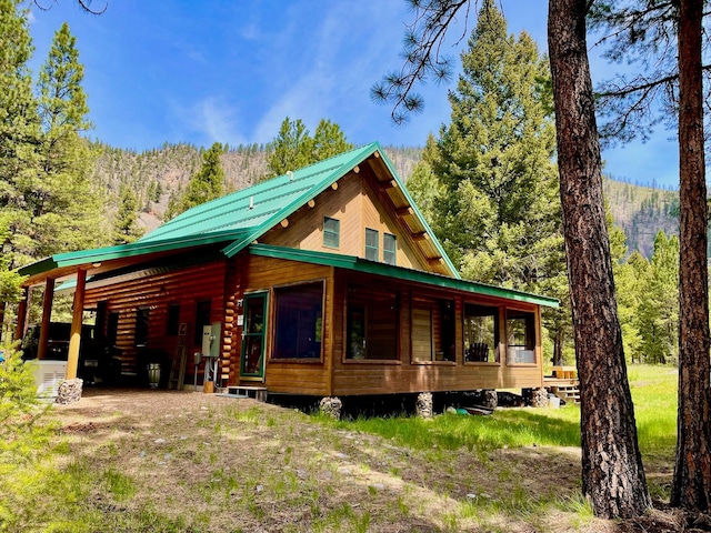 30 Williams Gulch Loop, Philipsburg, MT 59858 - view of front facade featuring a carport, a view of trees, and a metal roof