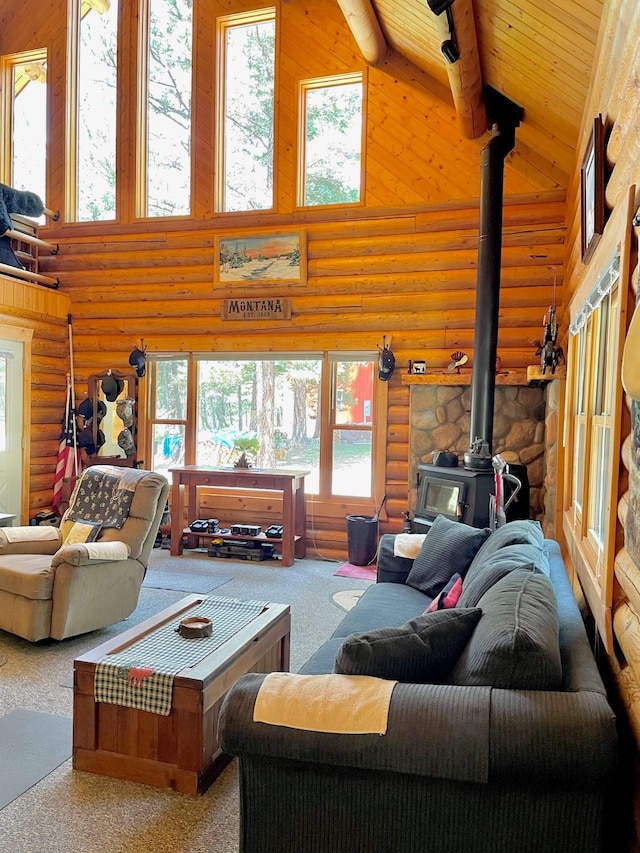 30 Williams Gulch Loop, Philipsburg, MT 59858 - living area featuring a wood stove, rustic walls, high vaulted ceiling, carpet flooring, and healthy amount of natural light